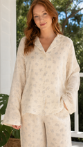 Close-up of cream floral lounge set with long sleeve collared top and matching pants